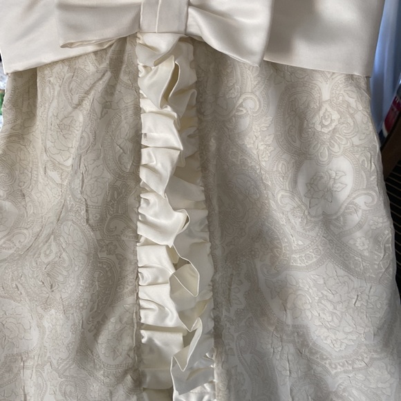Custom made ivory tone on tone sleeveless dress with satin ruffle and bow. - Picture 2 of 7